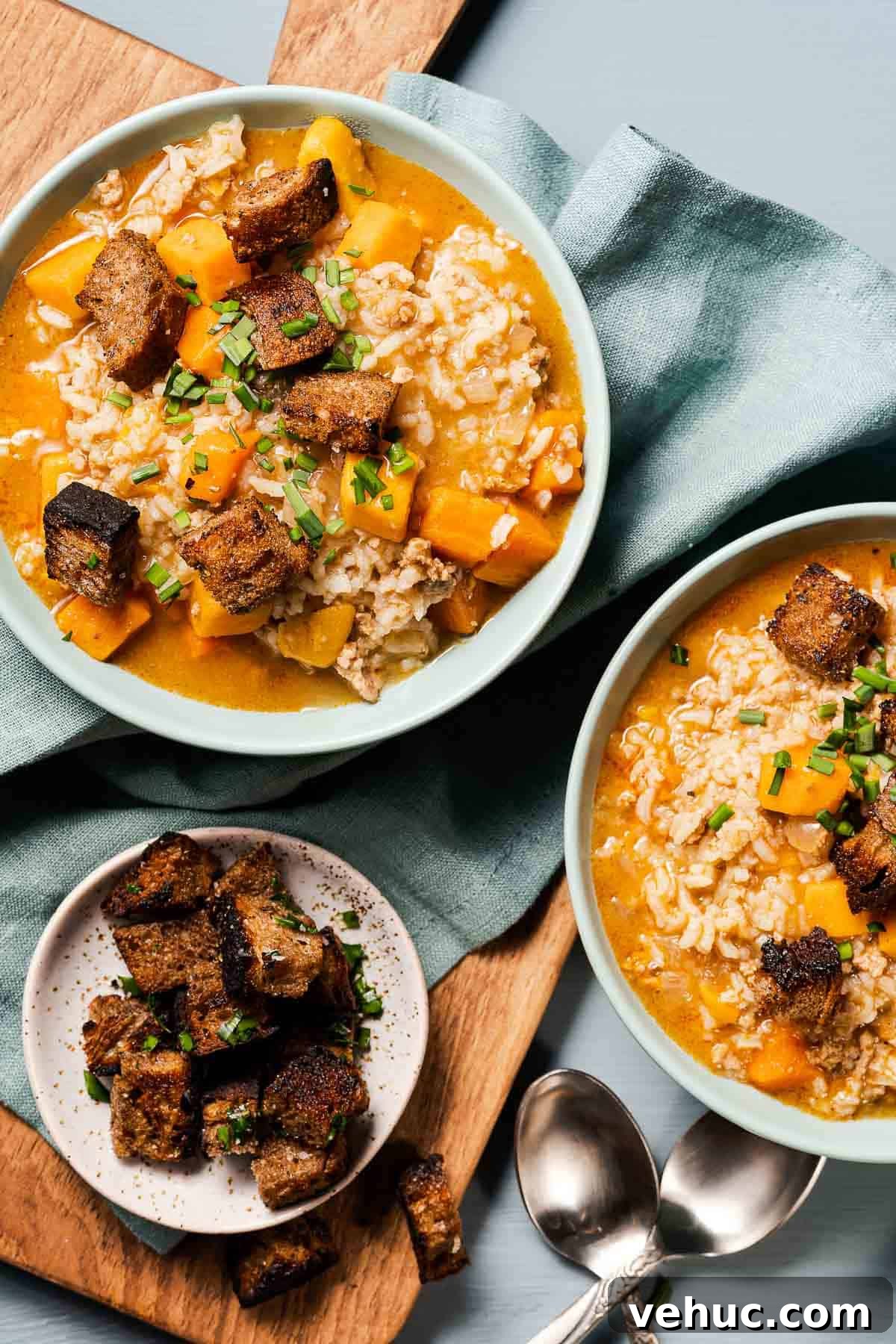 Roasted Turkey and Sweet Potato Soup Recipe 13 two bowls of turkey sweet potato soup with croutons on the side