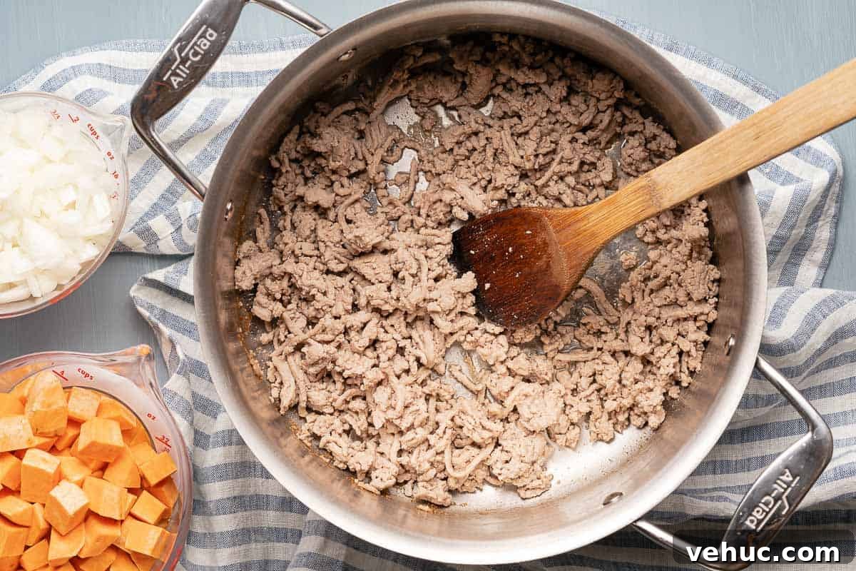Roasted Turkey and Sweet Potato Soup Recipe 6 ground turkey browned in pot with wooden spoon
