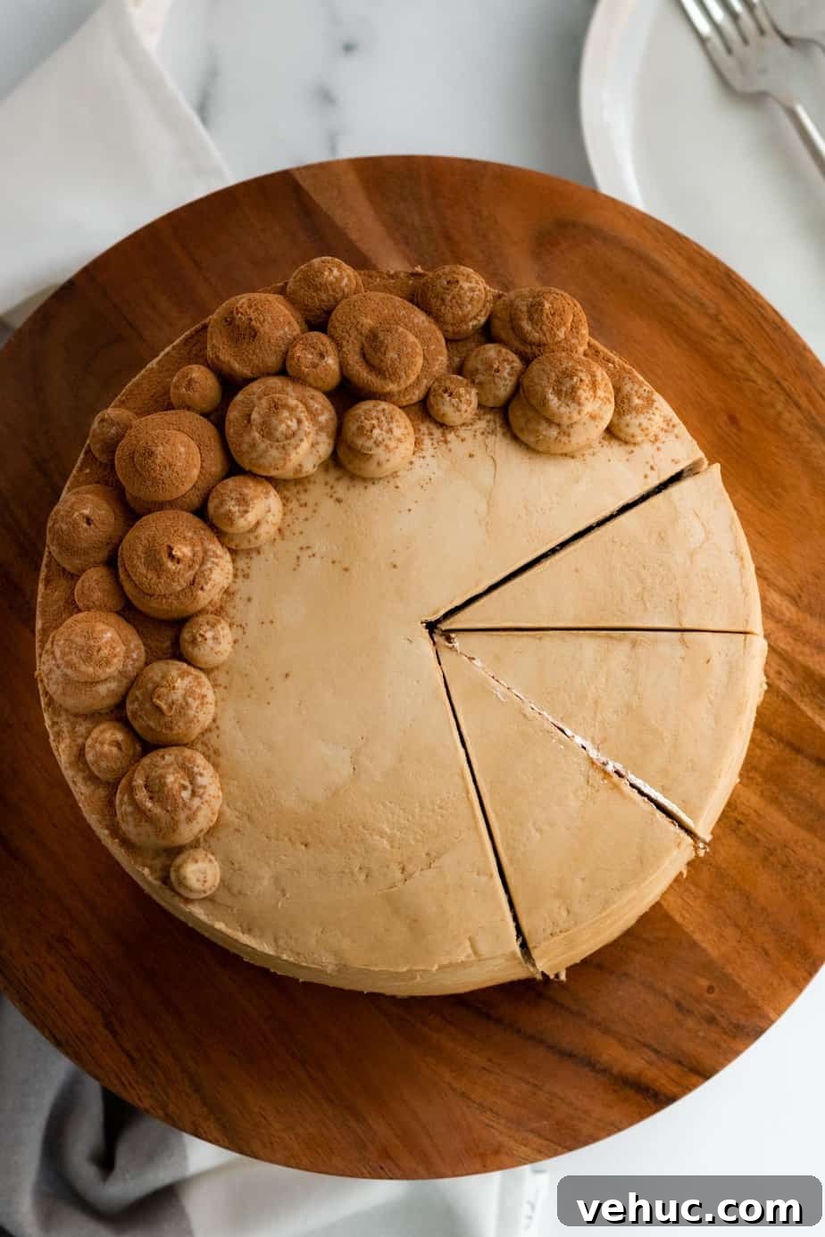Decadent Chocolate Mocha Cake Recipe with Espresso Frosting 10 chocolate mocha cake on a wood cake stand with 3 slices cut from the cake
