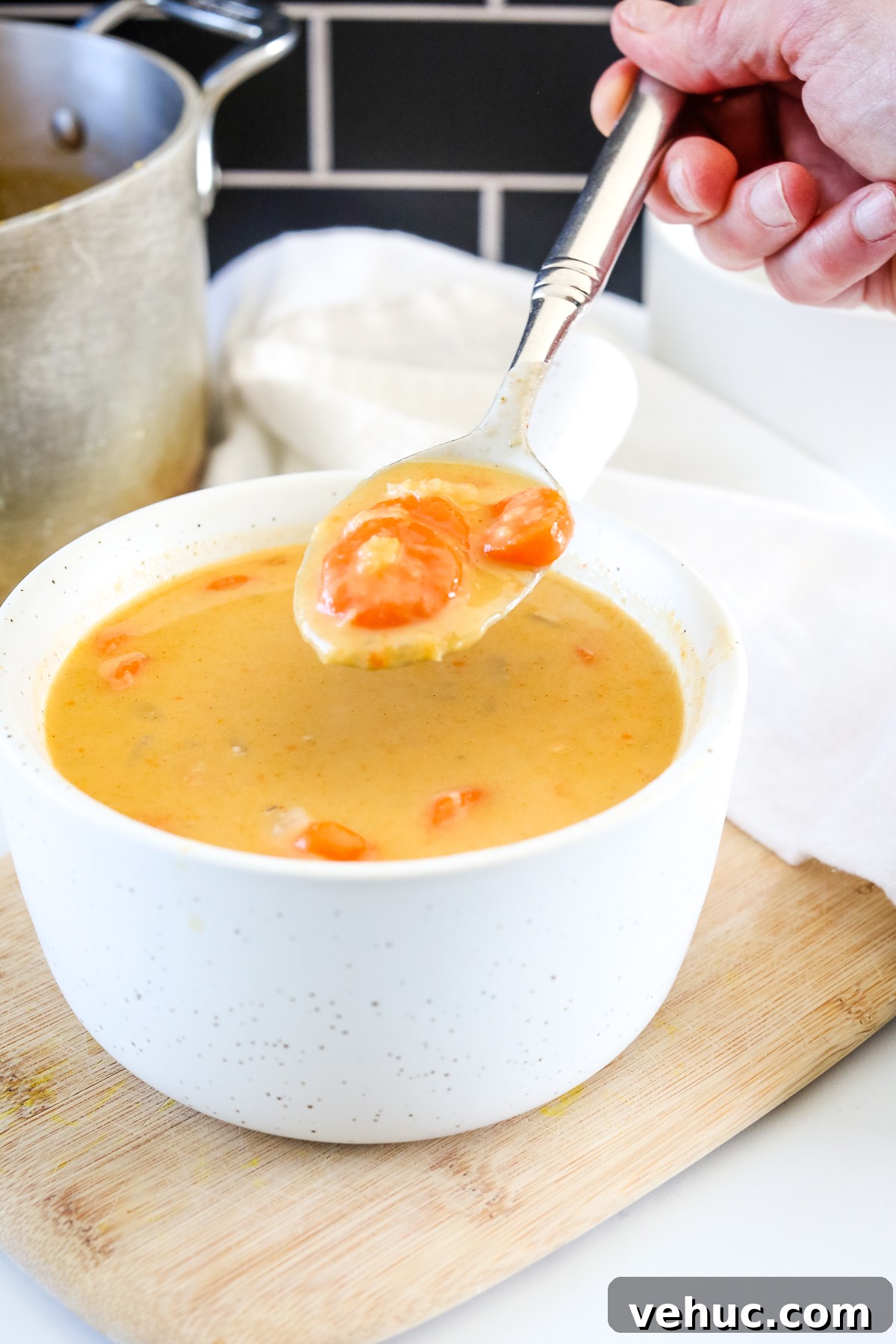 Creamy Broccoli and Cauliflower Soup Recipe for Comfort Meals 6 Carrot and Lentil Soup on a spoon from a white bowl