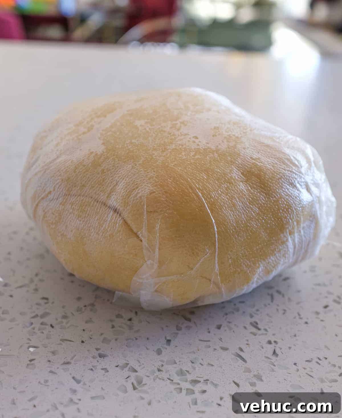 A ball of sweet pastry dough wrapped in plastic for Italian Ricotta Pie