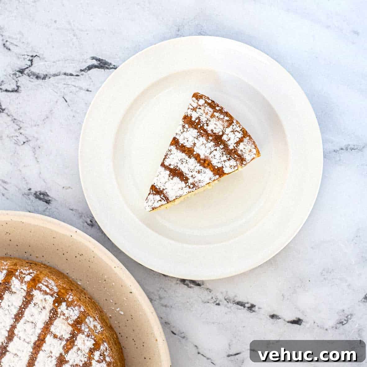 A slice of Italian Ricotta pie with the remaining pie in the background