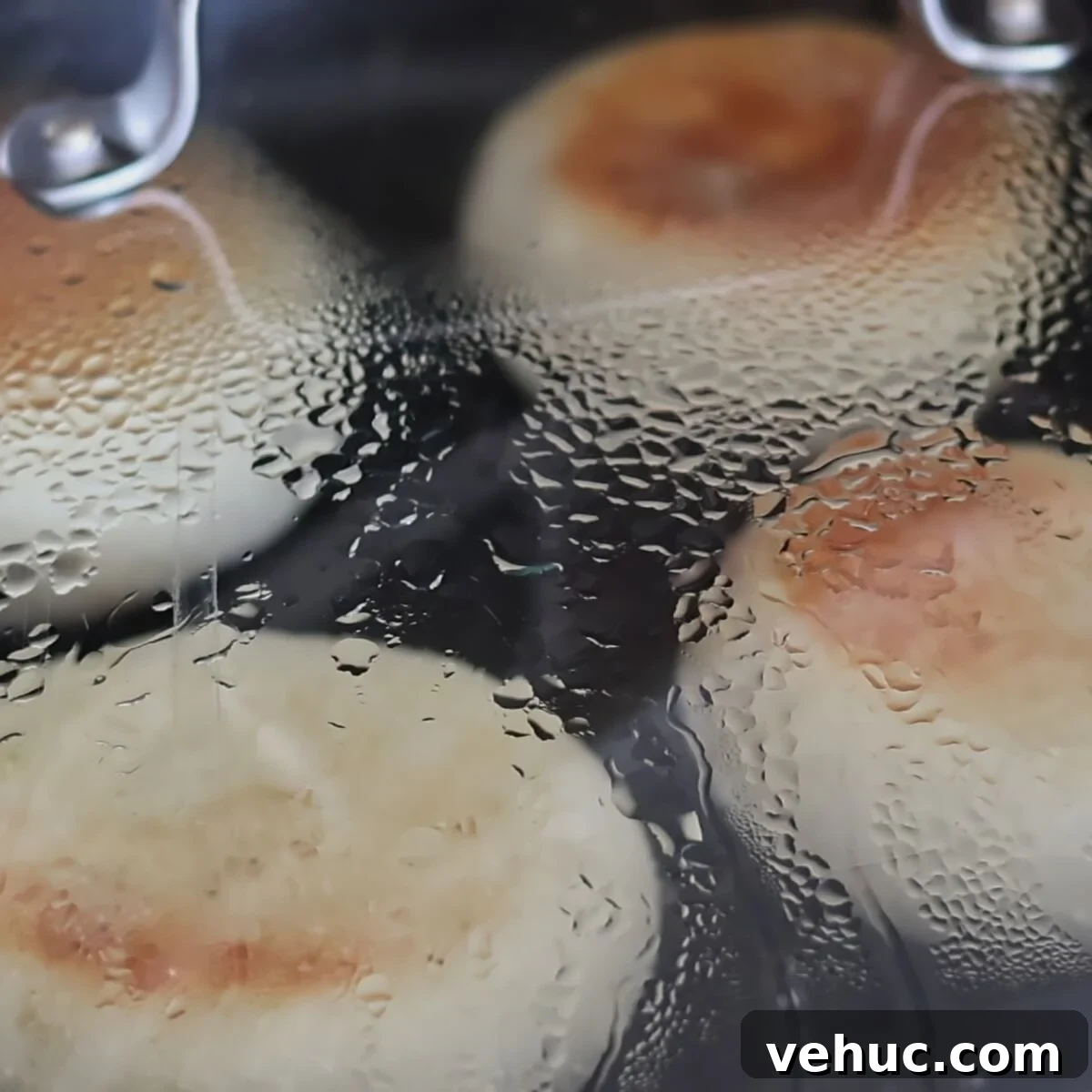 Gluten-Free Sourdough English Muffins Recipe You’ll Love 15 four muffins in skillet with glass lid on top.
