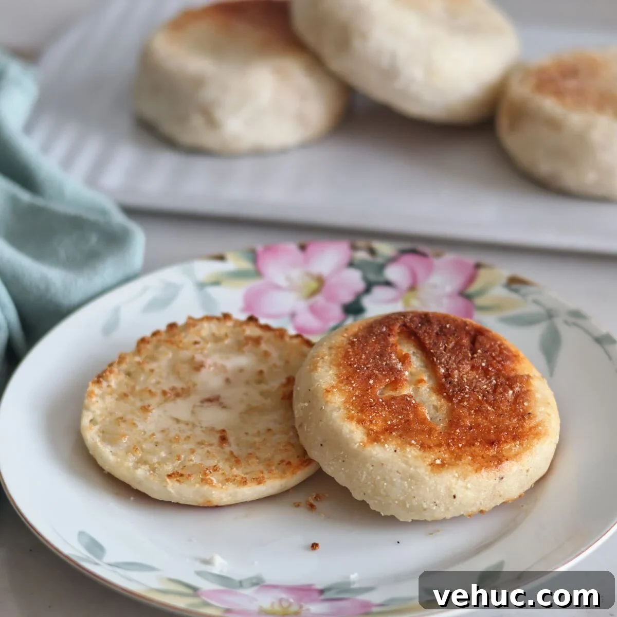 Gluten-Free Sourdough English Muffins Recipe You’ll Love 17 split open toasted english muffin on flowered plate.