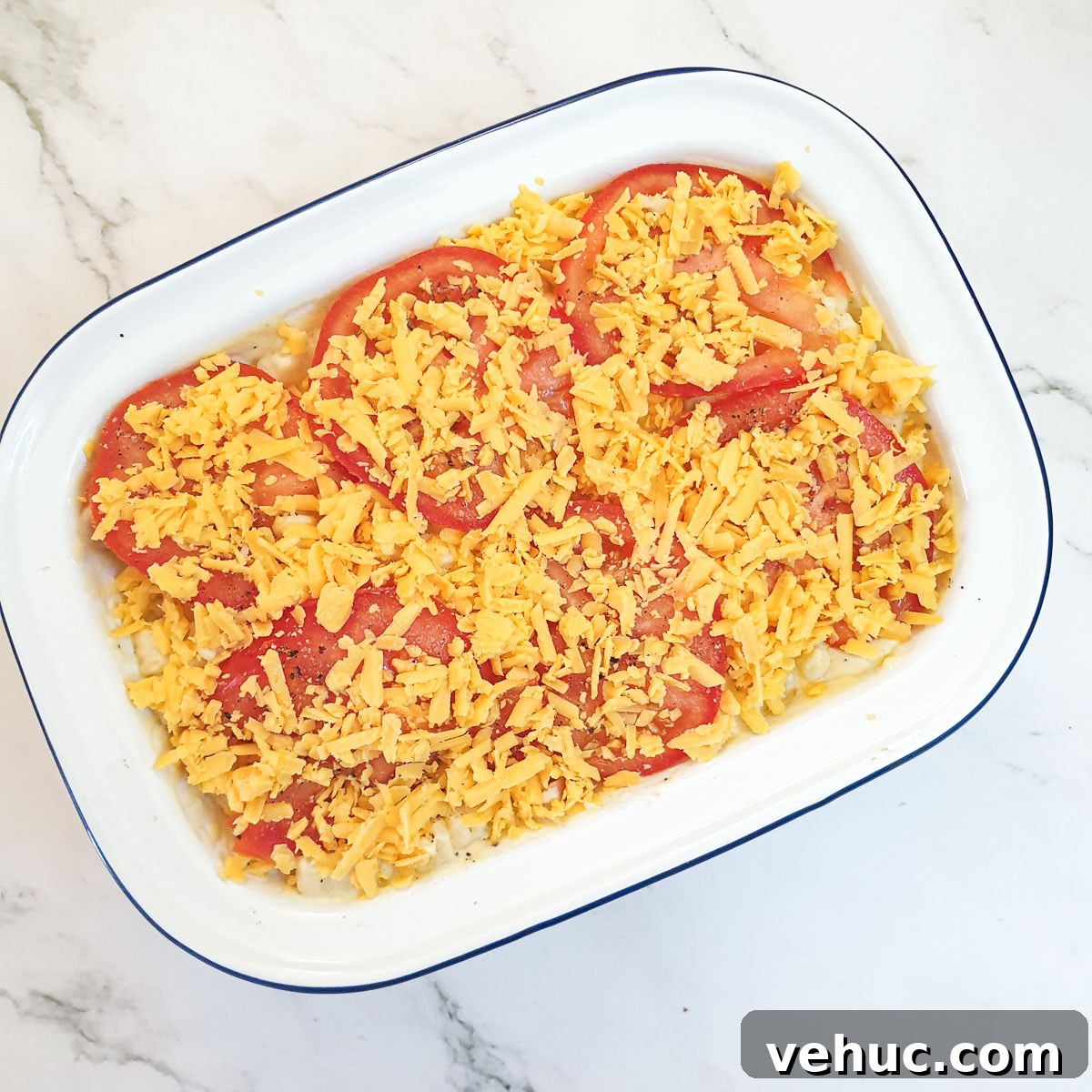 Ultimate Creamy Macaroni & Cheese Recipe for Comfort Night 11 Macaroni cheese topped with sliced tomatoes and grated cheese.