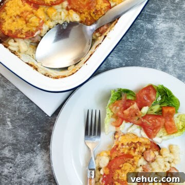 Ultimate Creamy Macaroni & Cheese Recipe for Comfort Night 17 A serving dish of macaroni cheese next to a helping on a plate.