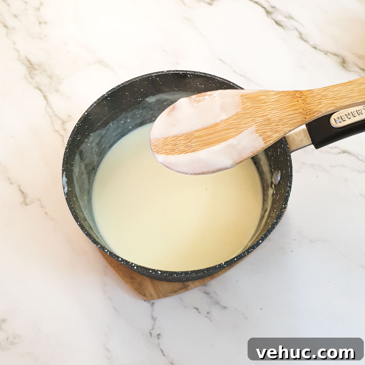 Ultimate Creamy Macaroni & Cheese Recipe for Comfort Night 6 A wooden spoon coated with sauce, showing the thickness of the sauce.