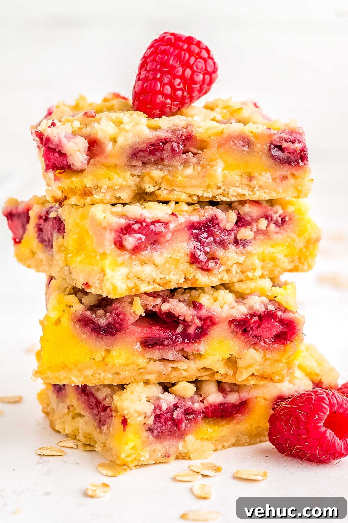 Chewy Raspberry Oat Bars with Homemade Jam Filling 2 Four raspberry oat bars stacked on top of each other.