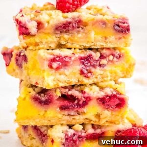 Chewy Raspberry Oat Bars with Homemade Jam Filling 8 Four raspberry oat bars stacked on top of each other.