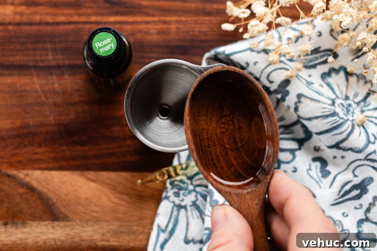 DIY Hair Growth Oil for Thicker, Fuller Hair in Weeks 3 Adding the jojoba oil to the small container.