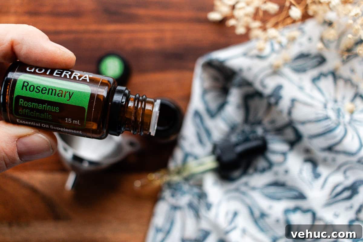 DIY Hair Growth Oil for Thicker, Fuller Hair in Weeks 4 Adding rosemary oil the the dropper bottle.