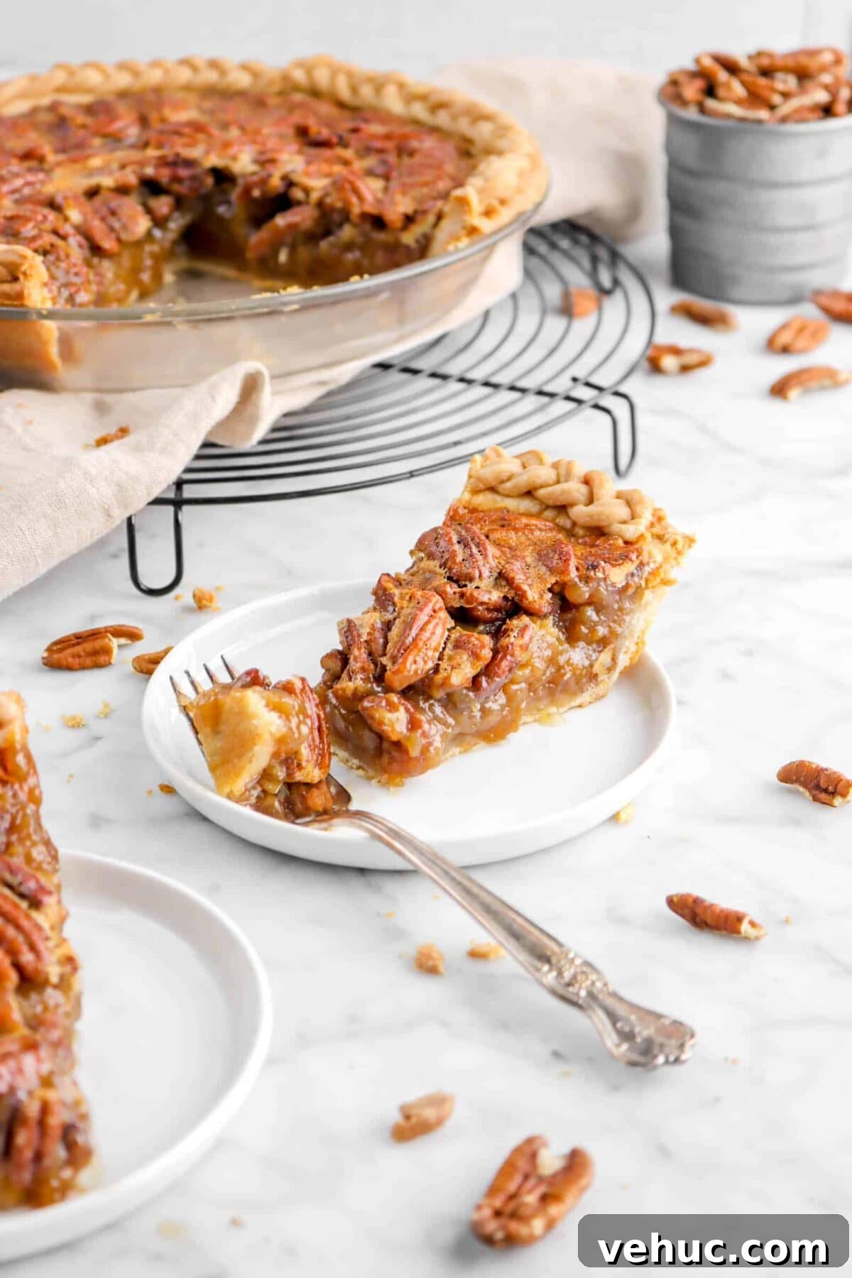 Top 21 Most-Loved Recipes of 2021: Trending Dishes You’ll Want to Try 13 slice of pecan pie with fork on white plate with pecan pie behind