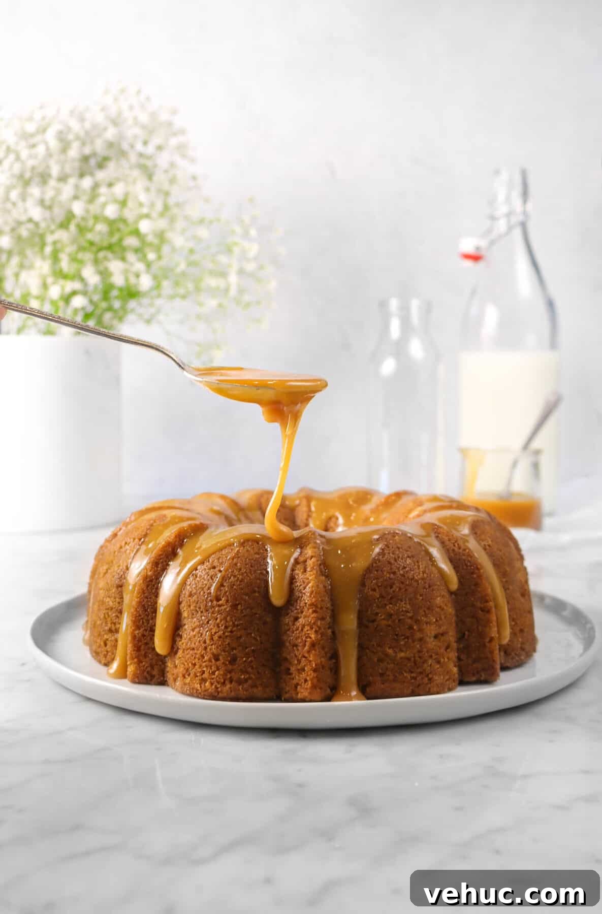 Top 21 Most-Loved Recipes of 2021: Trending Dishes You’ll Want to Try 21 apple cinnamon cake on a white plate with caramel being drizzled onto it