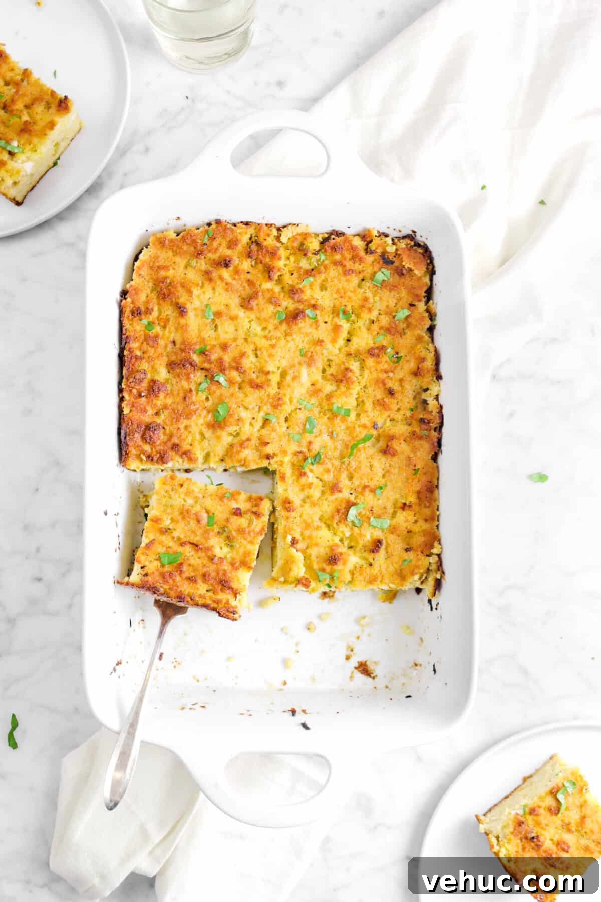 Top 21 Most-Loved Recipes of 2021: Trending Dishes You’ll Want to Try 22 cornbread dressing with a slice sitting in the pan and two plates of dressing