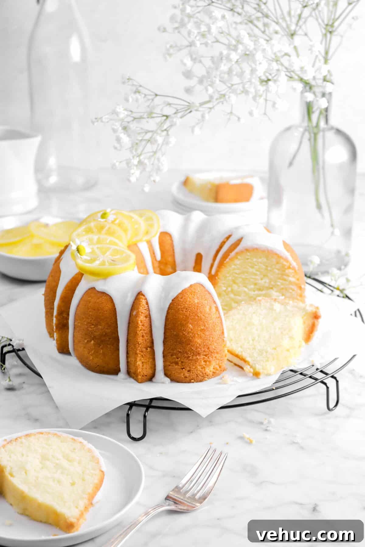 Top 21 Most-Loved Recipes of 2021: Trending Dishes You’ll Want to Try 23 bundt cake on wire cooling rack with flowers, a slice in front, slice behind, and candied lemon slices