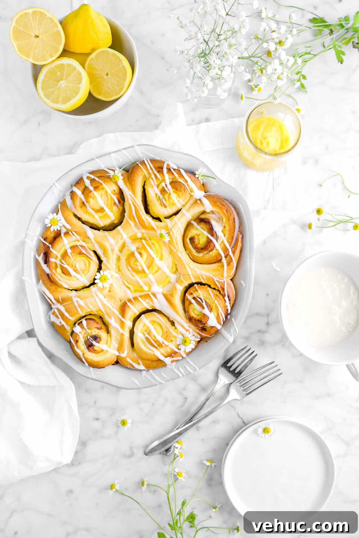 Top 21 Most-Loved Recipes of 2021: Trending Dishes You’ll Want to Try 4 overhead shot of lemon rolls in pie pan with a napkin, forks, lemons, flowers, lemon curd, and plates
