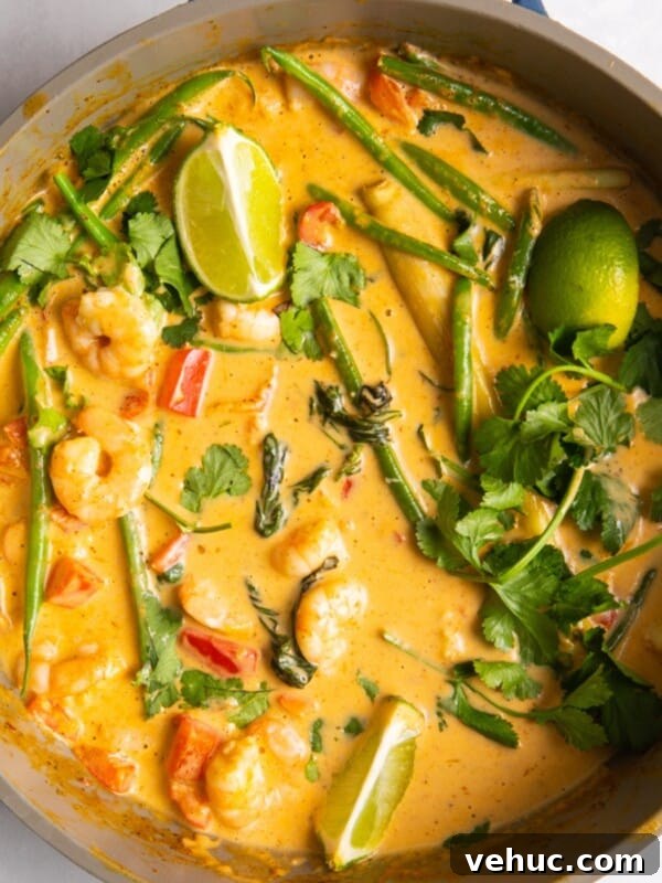 Creamy Garlic Prawn Linguine Recipe for Quick Weeknight Dinners 10 overhead shot of Thai red prawn curry in large shallow frying pan.