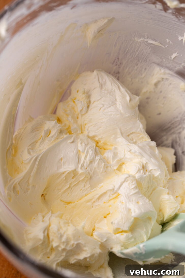 Silky Chocolate Cream Cheese Frosting Recipe for Cakes & Cupcakes 4 Whipped butter in a bowl.
