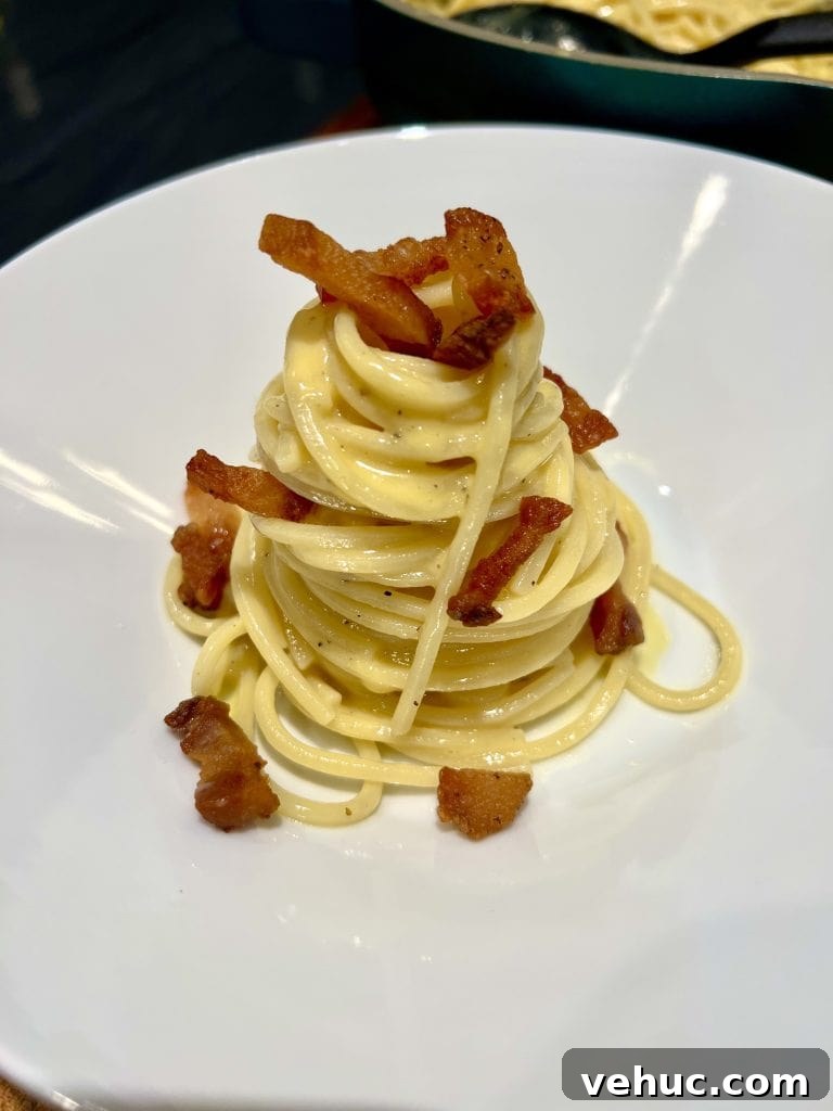 Authentic Carbonara Recipe: How to Make Classic Pasta Like a Pro 2 Plate of spaghetti carbonara topped with crispy guanciale and black pepper