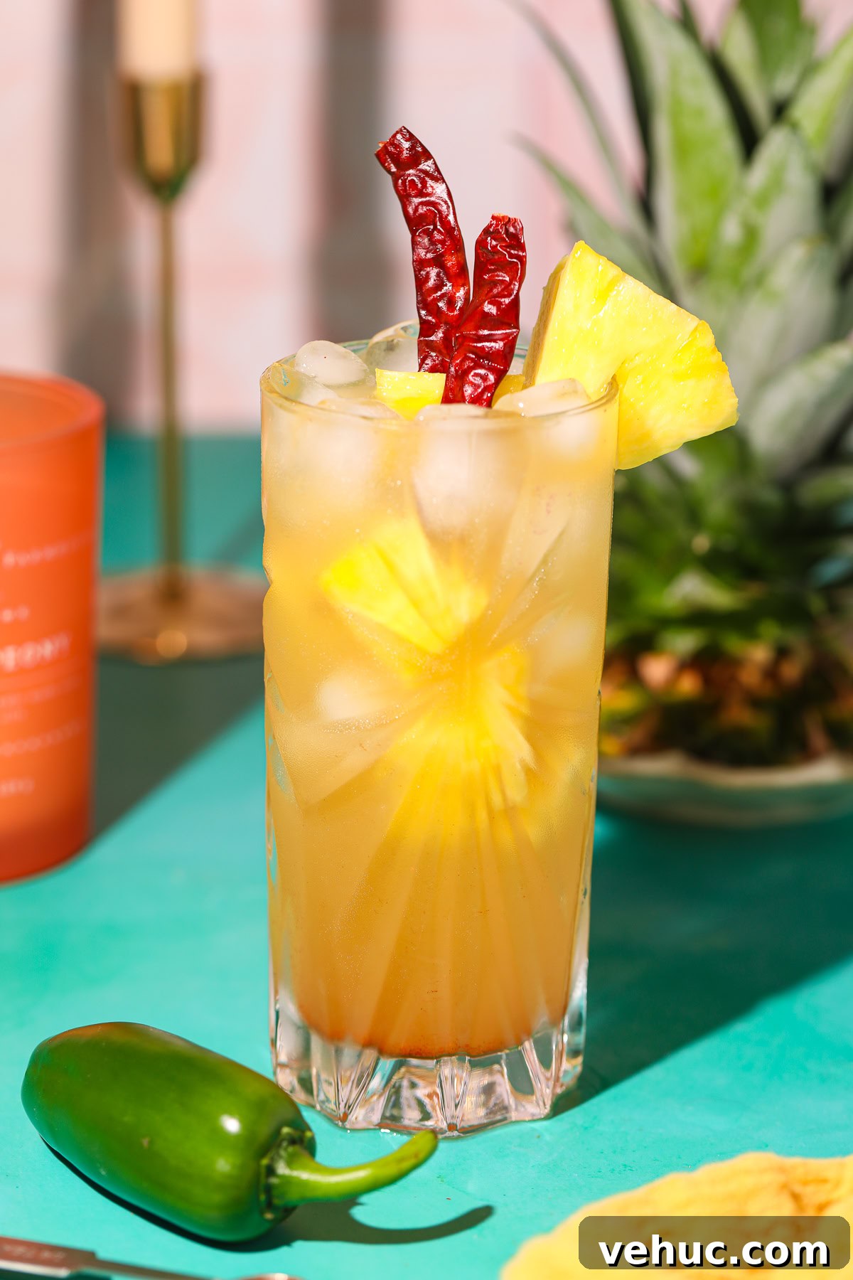 Spicy Pineapple Lemonade Recipe: Tangy Pineapple Citrus Cooler 2 spicy pineapple lemonade in a glass on a table with a pineapple in the background.
