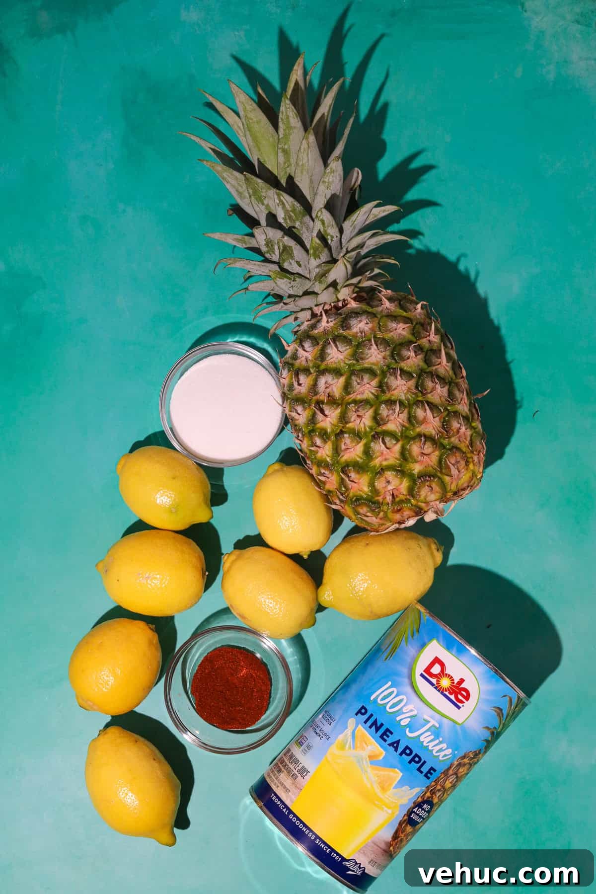 Spicy Pineapple Lemonade Recipe: Tangy Pineapple Citrus Cooler 3 ingredients for spicy pineapple lemonade lying on a table.
