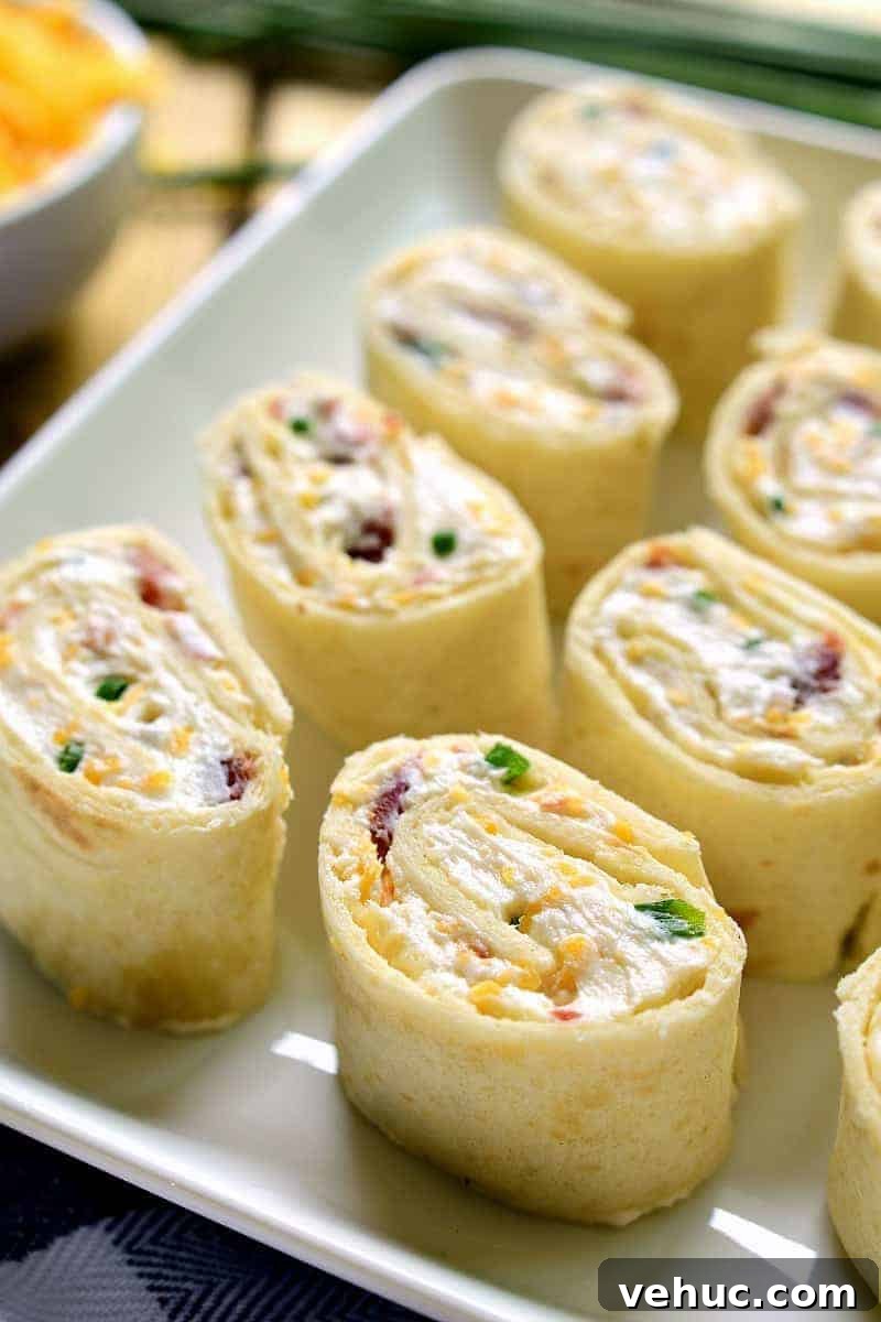 27 Festive Christmas Finger Food Appetizers for Holiday Parties 11 Bacon cheddar pinwheels for the holidays