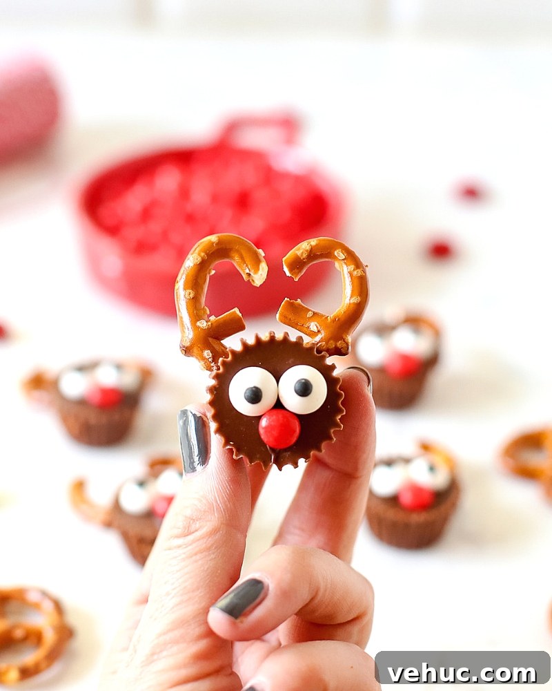 27 Festive Christmas Finger Food Appetizers for Holiday Parties 22 Fingers holding a Reese's Reindeer
