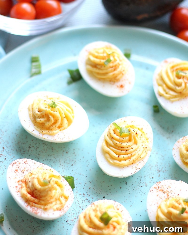 27 Festive Christmas Finger Food Appetizers for Holiday Parties 6 Blue plate full of deviled eggs.