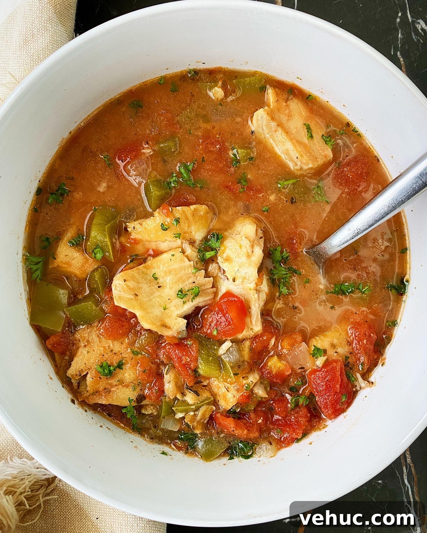 Mediterranean Slow-Cooker Fish Stew with Video Tutorial 2 overhead shot of Slow Cooker Mediterranean Fish Stew in a white bowl