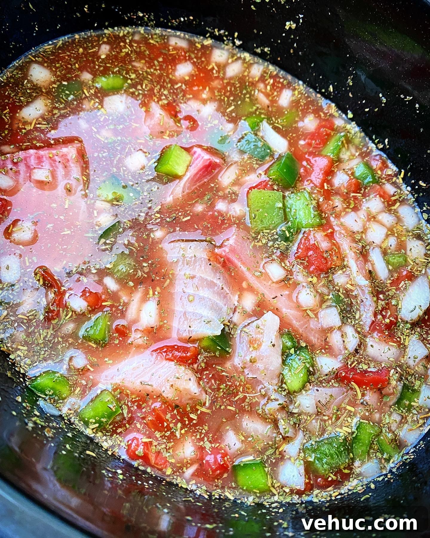 Mediterranean Slow-Cooker Fish Stew with Video Tutorial 4 overhead shot of uncooked Slow Cooker Mediterranean Fish Stew in a black slow cooker