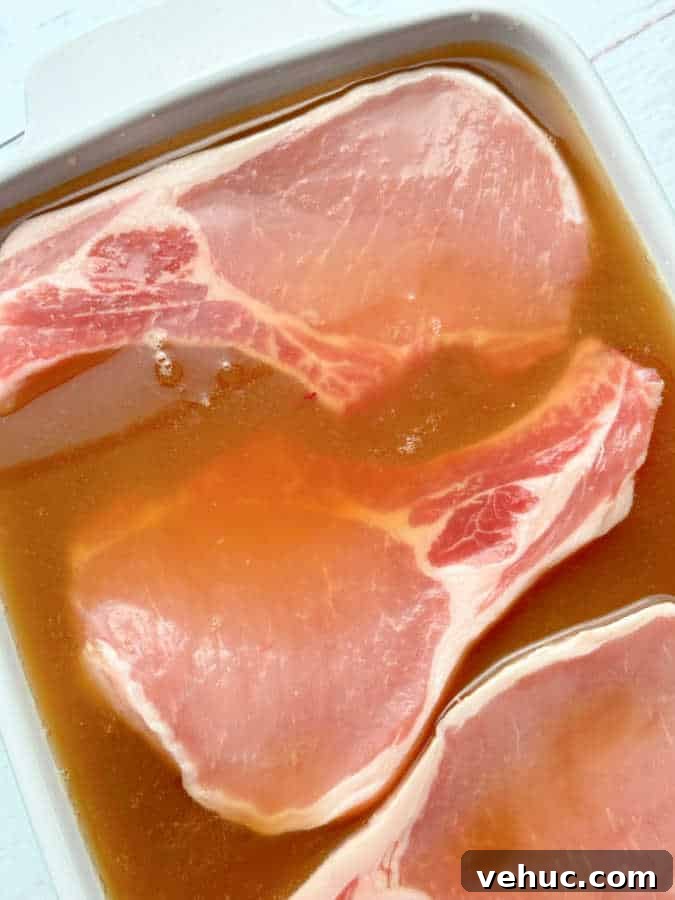 How to Brine Pork Chops for Juicy, Flavorful Results 6 pork chops in a dish being brined