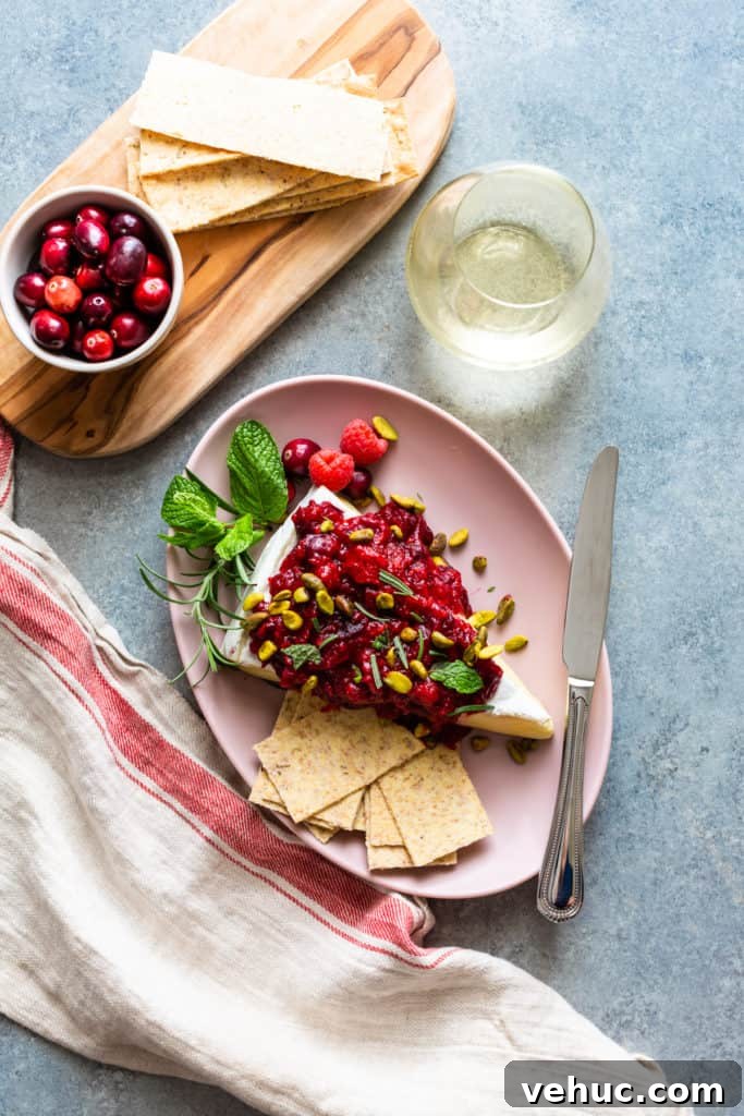 71 Festive Christmas Party Appetizers Your Guests Will Love 28 baked brie with cranberry raspberry sauce