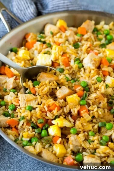 Crispy Oven-Baked Chicken Thighs with Garlic and Herbs 6 A serving spoon in a pan of chicken fried rice.