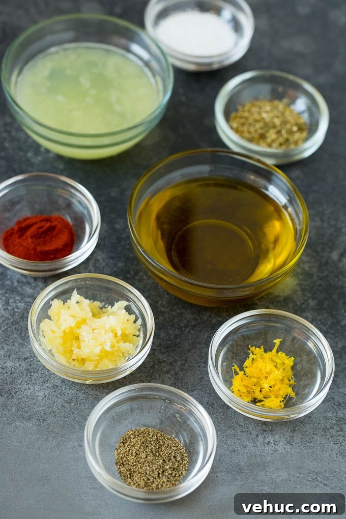 Marinade ingredients Bowls of lemon juice, olive oil, herbs and spices to make chicken marinade.
