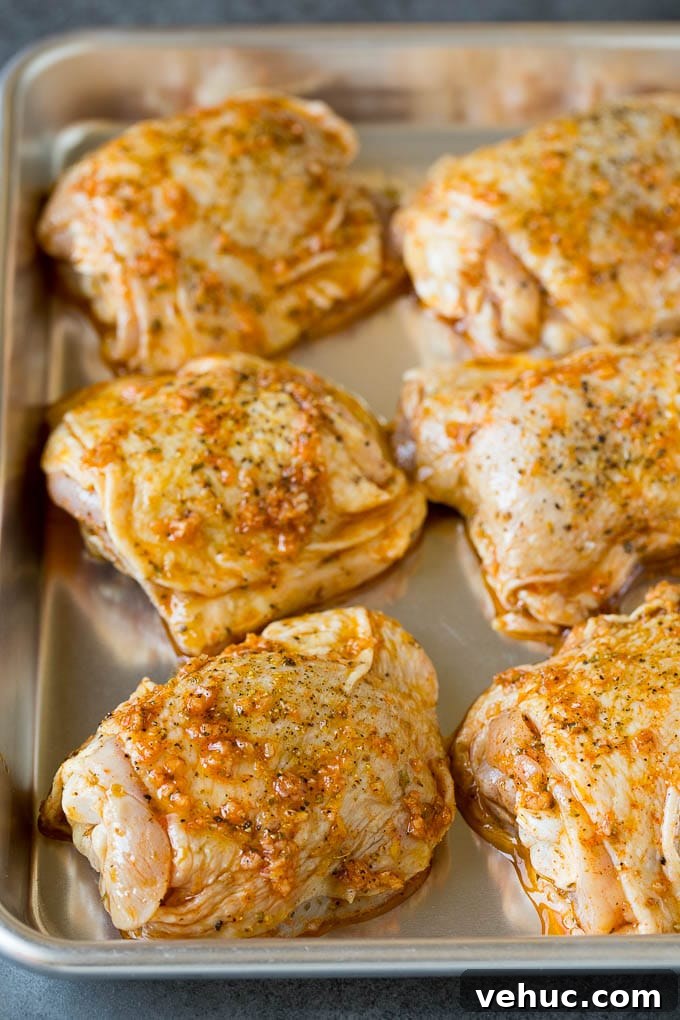 Marinated chicken on sheet pan Marinated chicken thighs on a sheet pan.