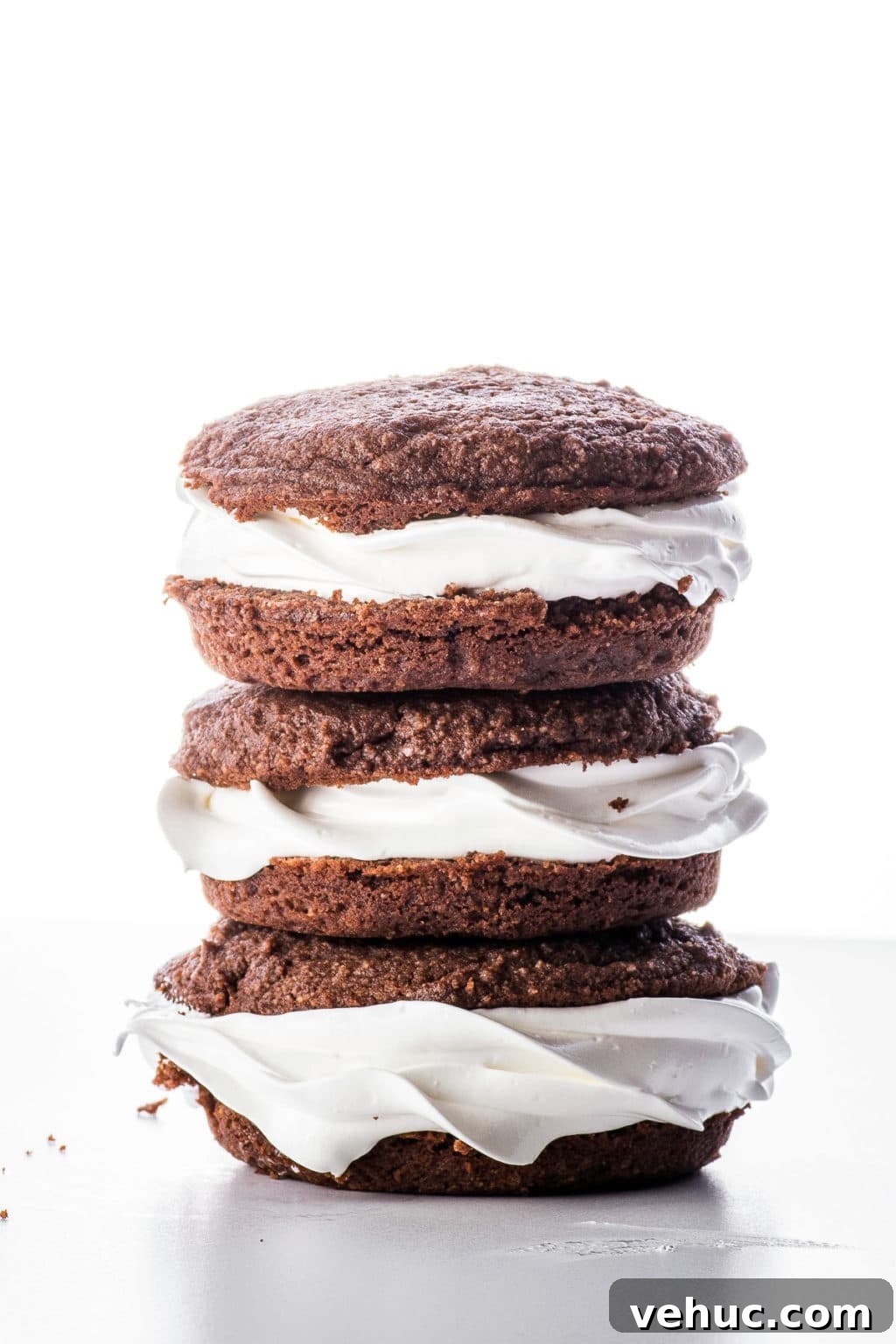 Keto Whoopie Pies with Marshmallow Filling — Low-Carb Gluten-Free 3 Stacked chocolate keto whoopie pies on a bright white back ground