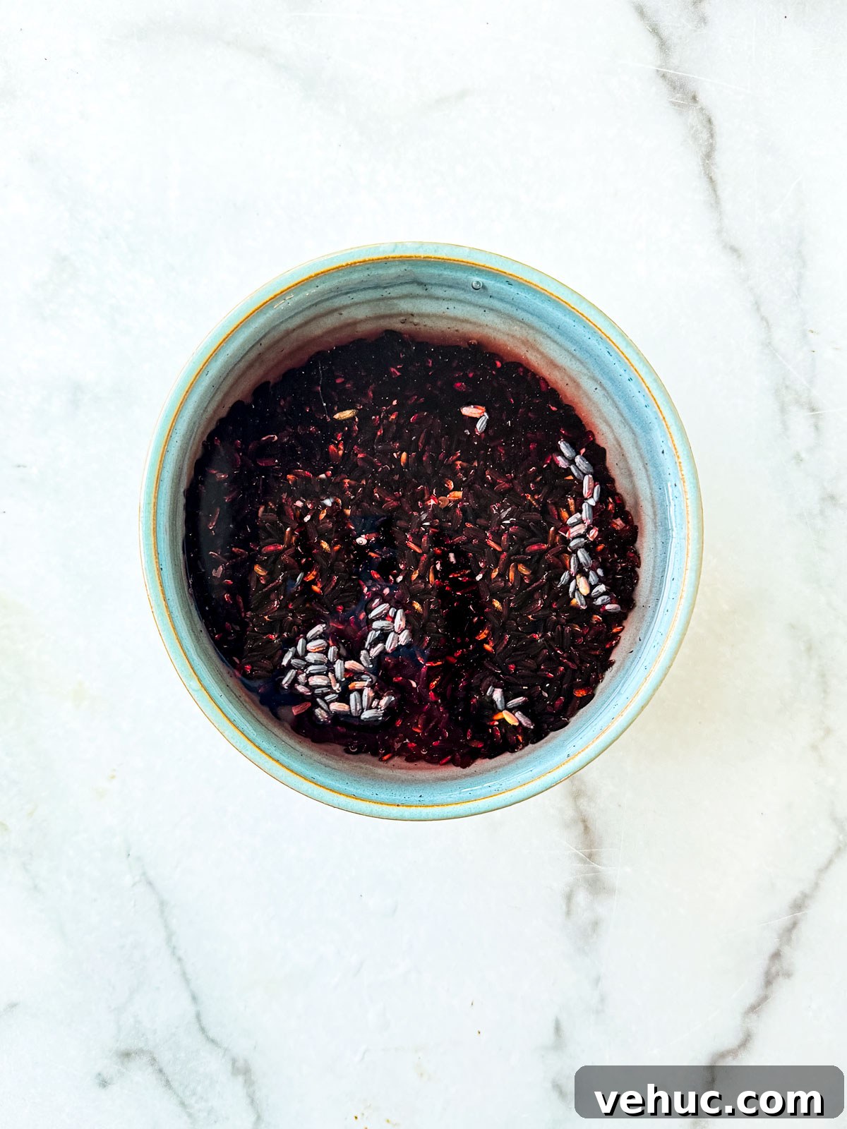 Teriyaki Salmon Bowl Recipe with Rice and Veggies 4 Black rice being soaked in cold water.