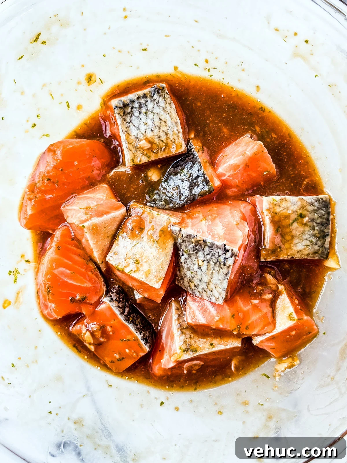 Teriyaki Salmon Bowl Recipe with Rice and Veggies 5 Salmon cubes marinating in a mixing bowl.