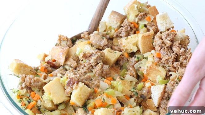 Savory Sausage and Herb Stuffing Recipe for Holiday Dinners 5 tossing cubed bread with veggies and sausage
