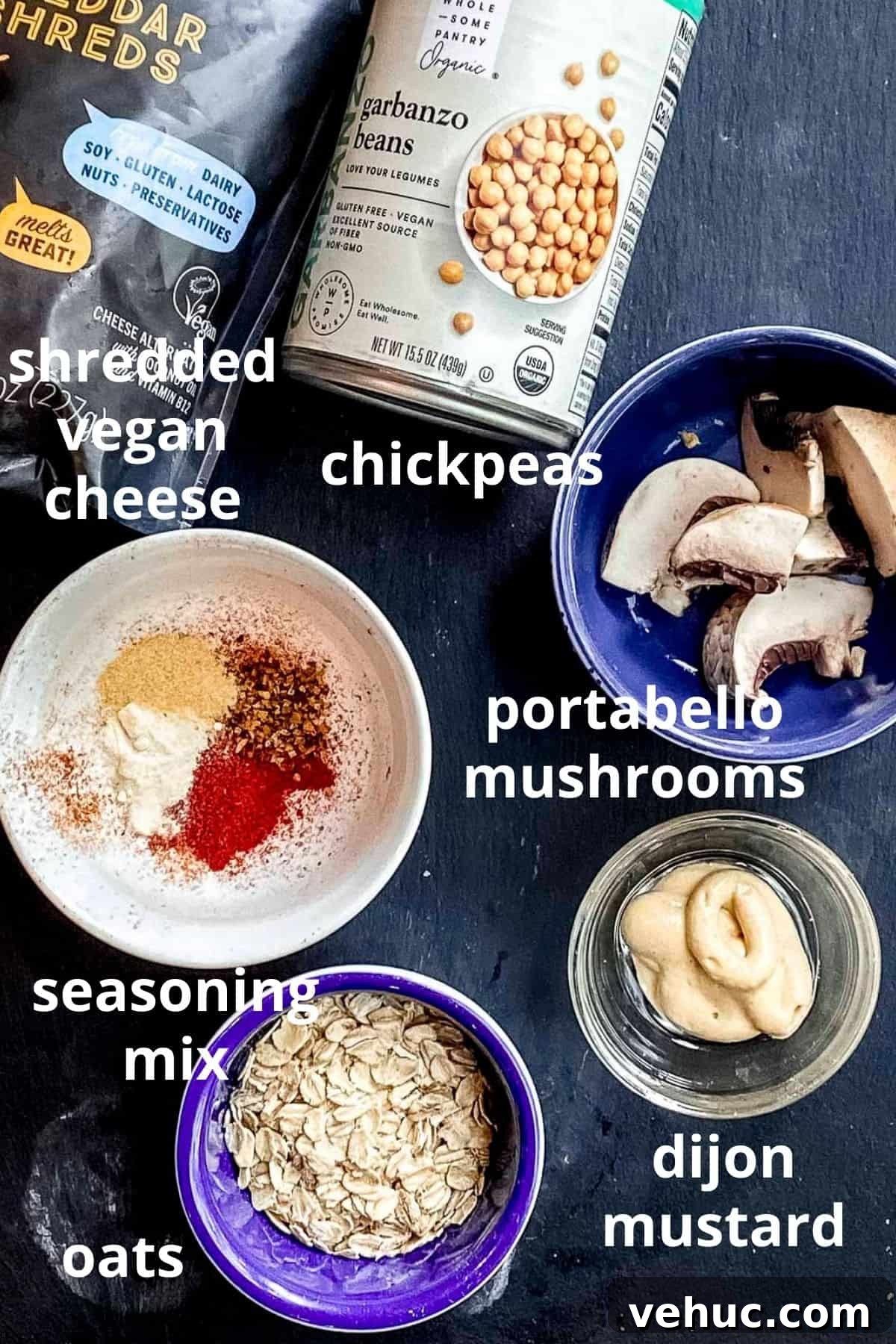 Vegan Meatballs in Savory Peanut Pumpkin Sauce 3 An overhead view of ingredients to make veggie meatballs; shredded vegan cheese, a can of chickpeas, portabello mushrooms, seasoning mix, dijon mustard and oats