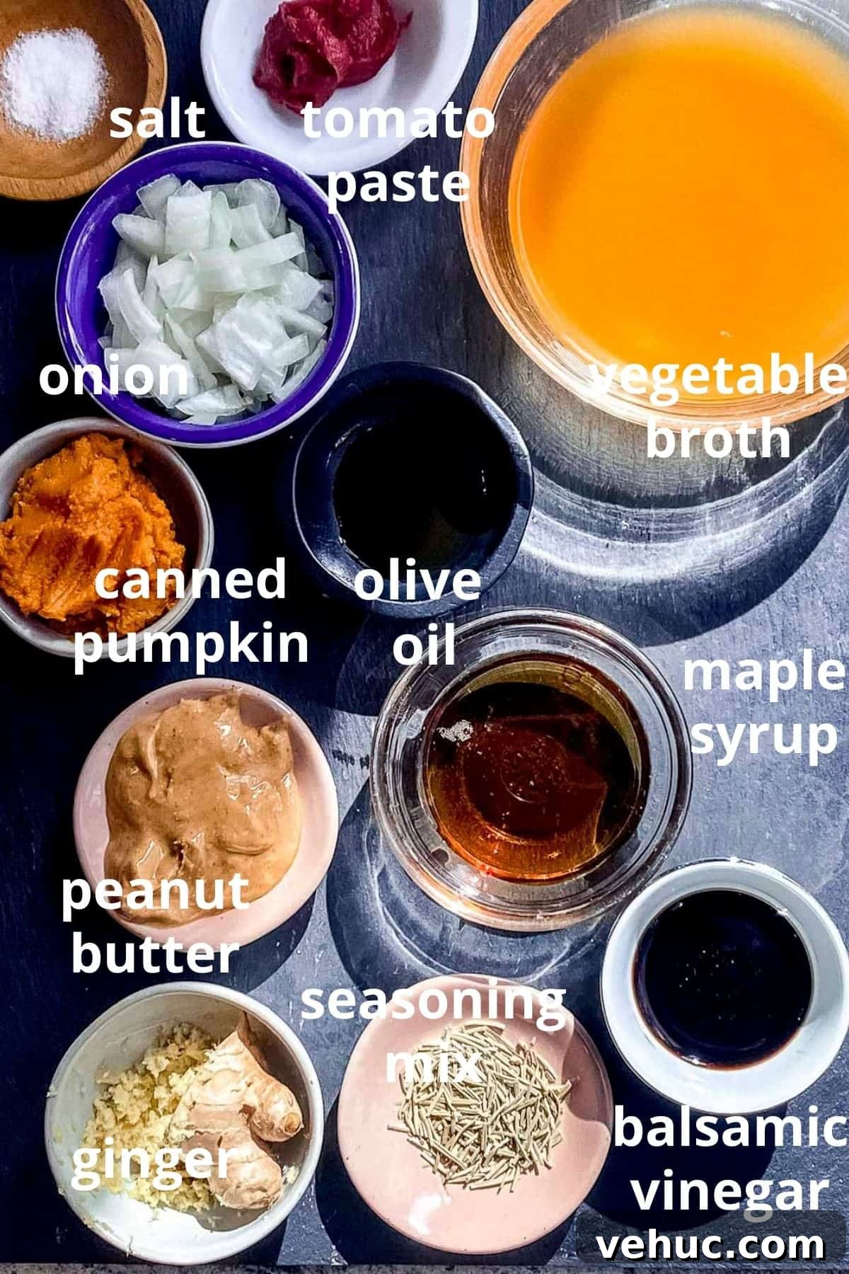 Vegan Meatballs in Savory Peanut Pumpkin Sauce 4 An overhead view of ingredients to make pumpkin sauce displayed in bowls; salt, tomato paste, vegetable broth, diced onion, canned pumpkin, olive oil, peanut butter, maple syrup, balsamic vinegar, seasoning mix, ginger