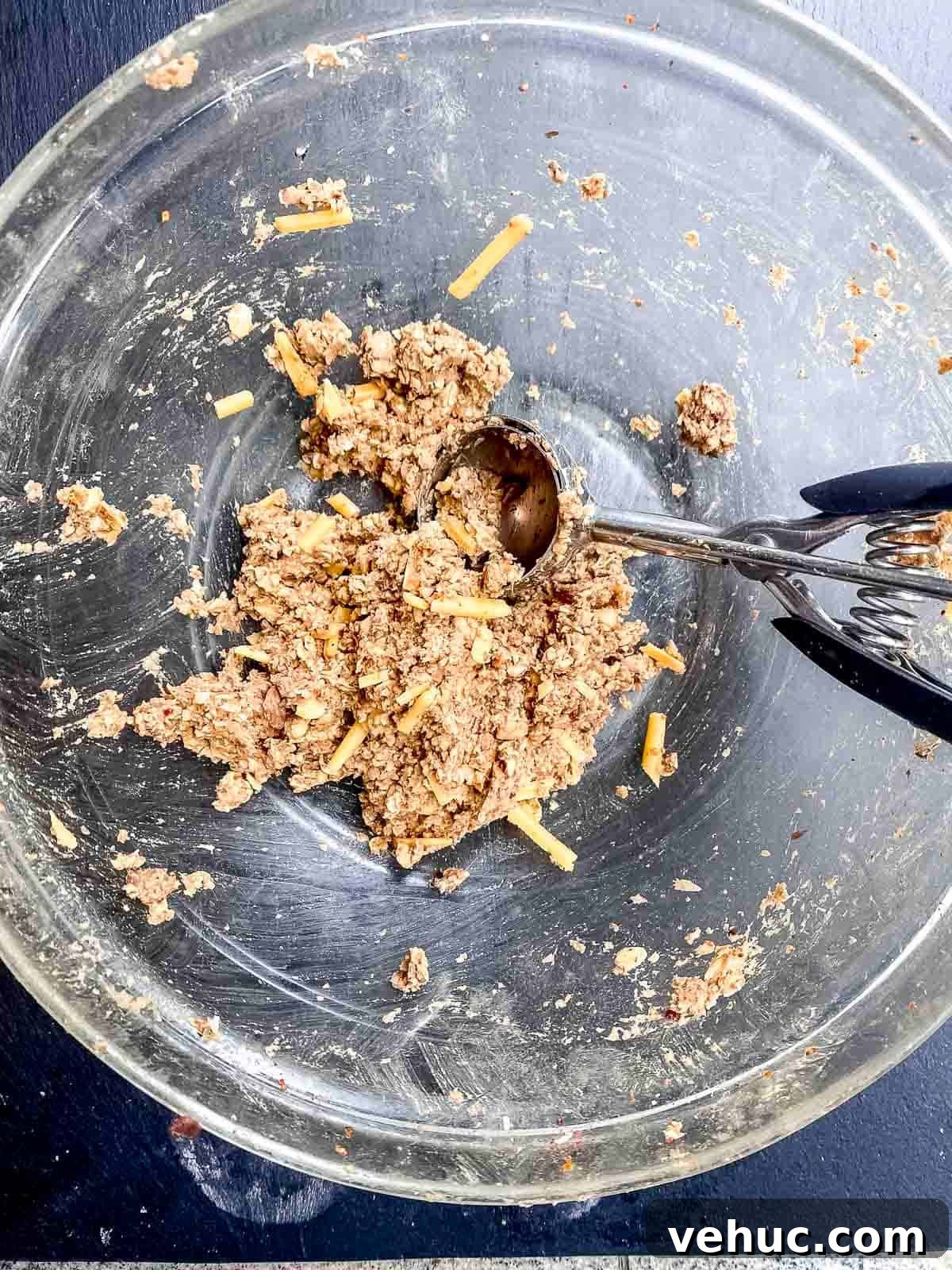 Vegan Meatballs in Savory Peanut Pumpkin Sauce 6 An overhead view of a mixing bowl with veggie meatballs mixture with a scoop