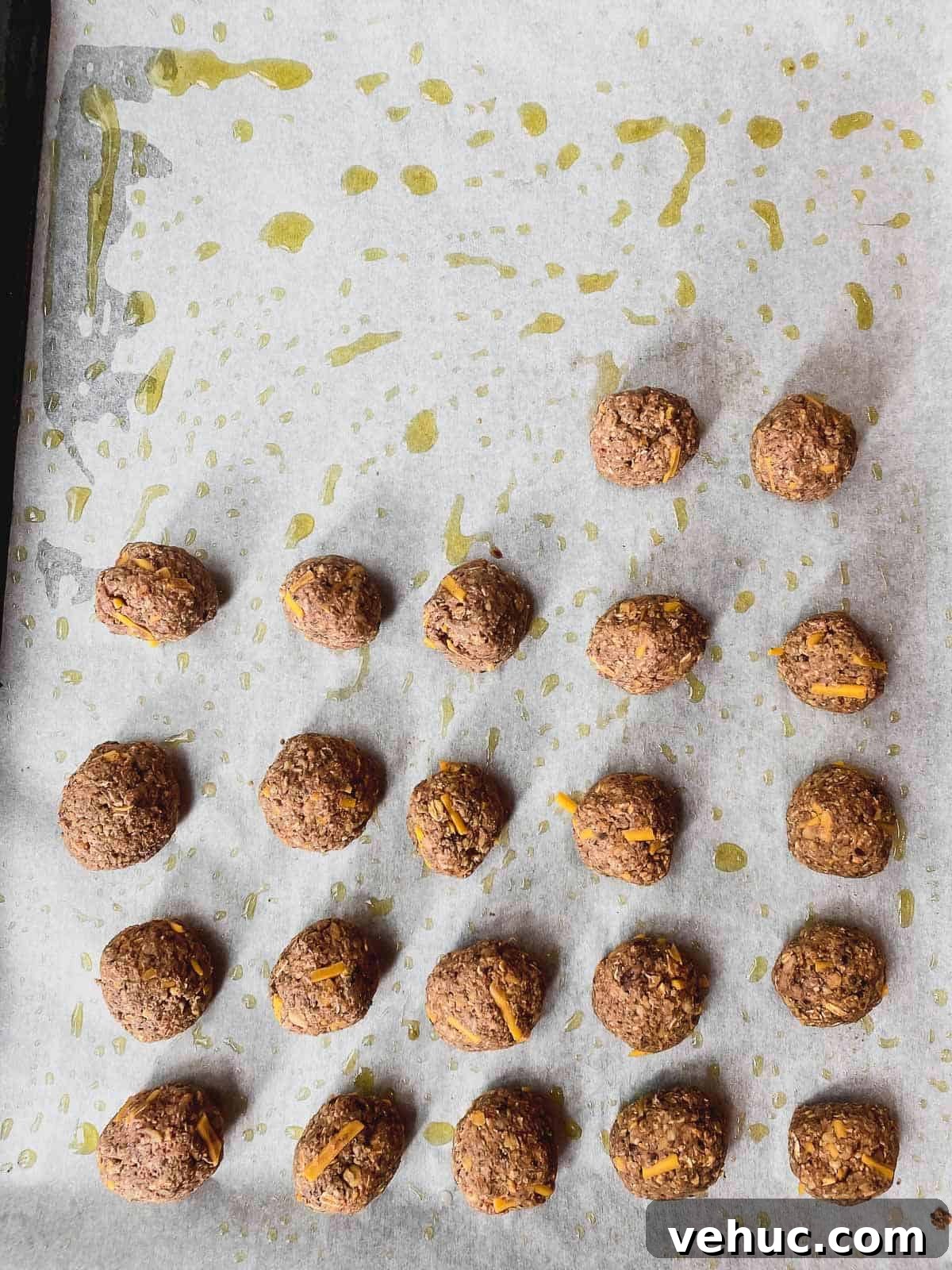Vegan Meatballs in Savory Peanut Pumpkin Sauce 7 An overhead view of a parchment lined baking sheet with veggie meatballs before being baked