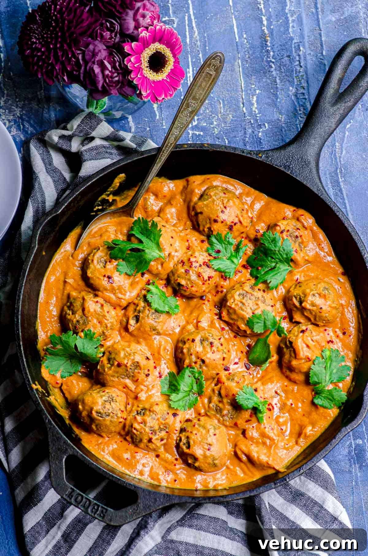 Vegan Meatballs in Savory Peanut Pumpkin Sauce 10 An overhead view of a cast iron skillet with Veggie Meatballs with Pumpkin sauce