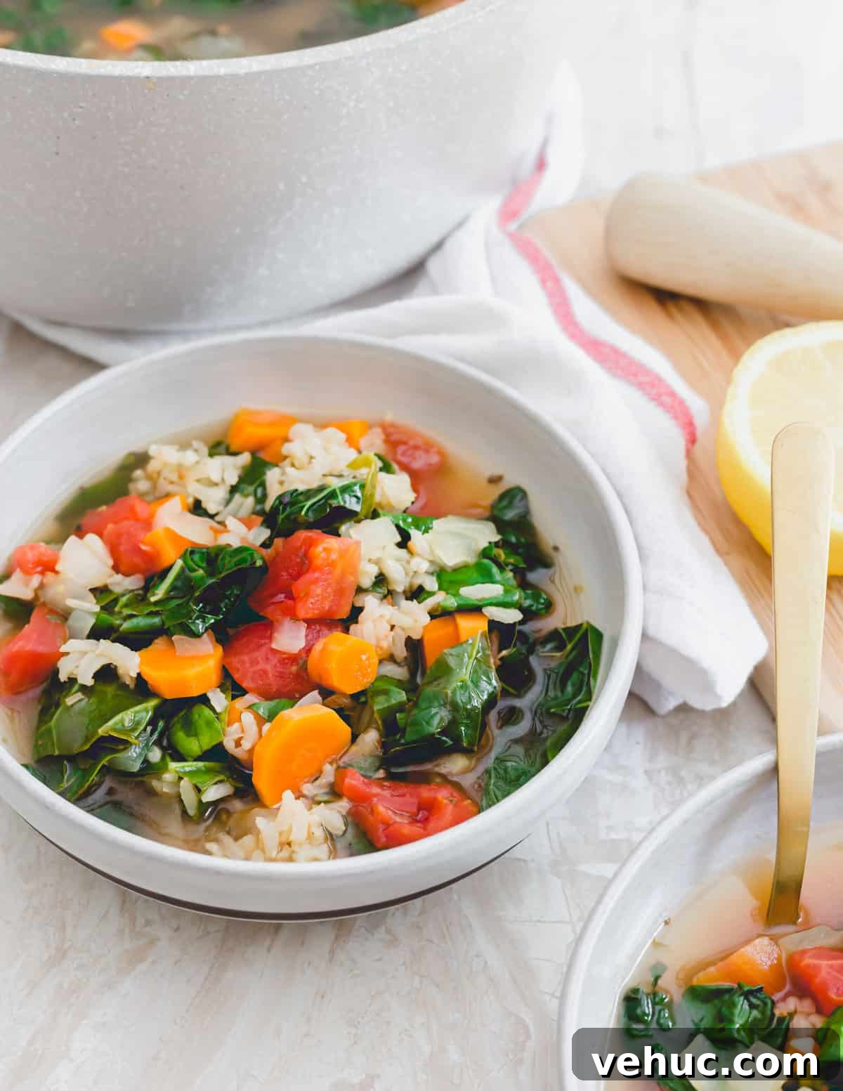 Vegetarian Tuscan kale soup with brown rice in a serving bowl. Vegetarian Tuscan kale soup with brown rice in a serving bowl.