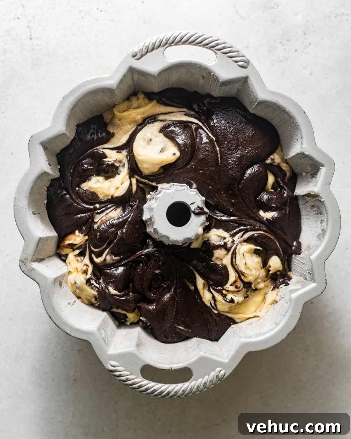Decadent Oreo Pound Cake Recipe: Moist Cookies and Cream Loaf 8 pouring batter into a bundt pan.
