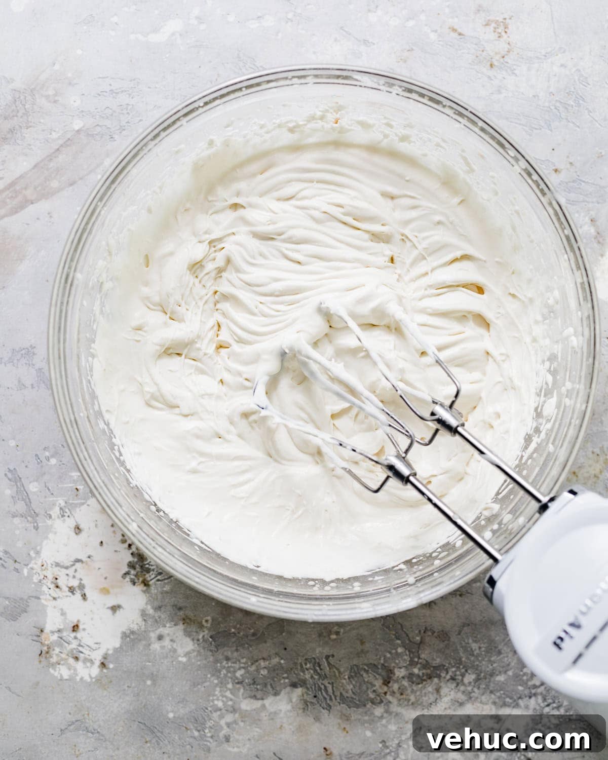 Decadent Oreo Pound Cake Recipe: Moist Cookies and Cream Loaf 9 cream cheese glaze being mixed.
