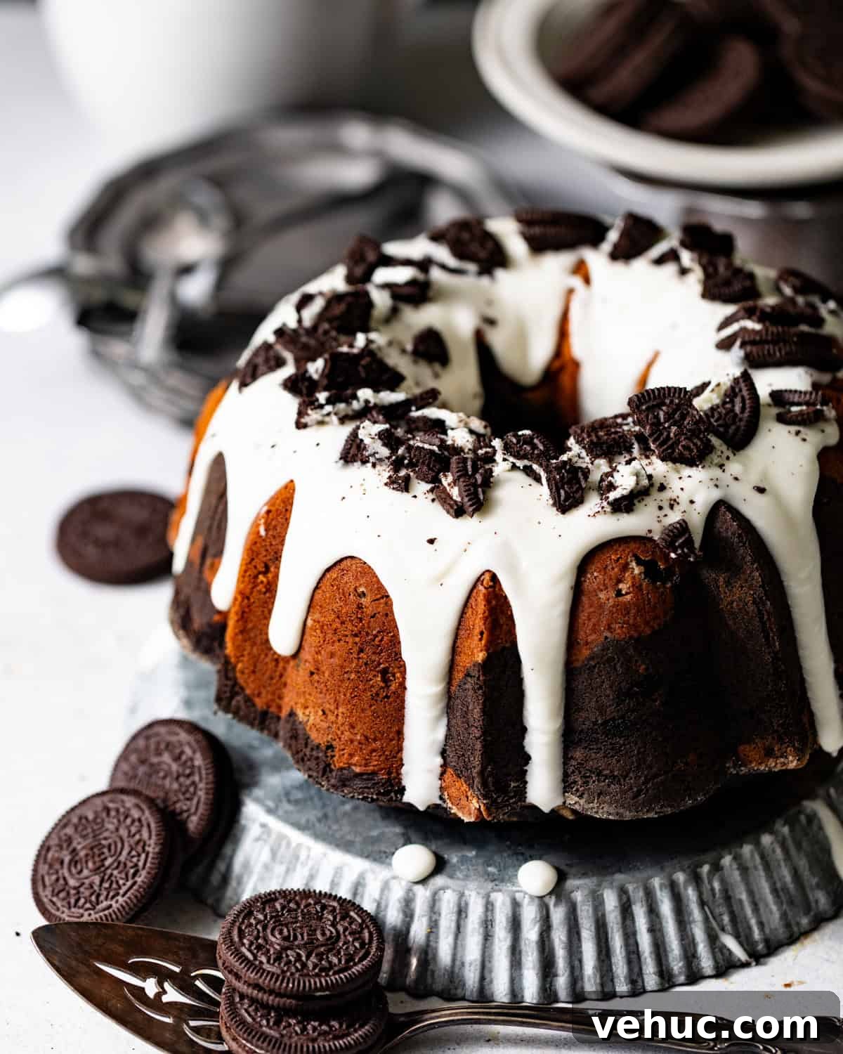 Decadent Oreo Pound Cake Recipe: Moist Cookies and Cream Loaf 10 oreo pound cake topped with cream cheese glaze and crushed oreos.