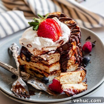 Stack of French toast with a slice removed.
