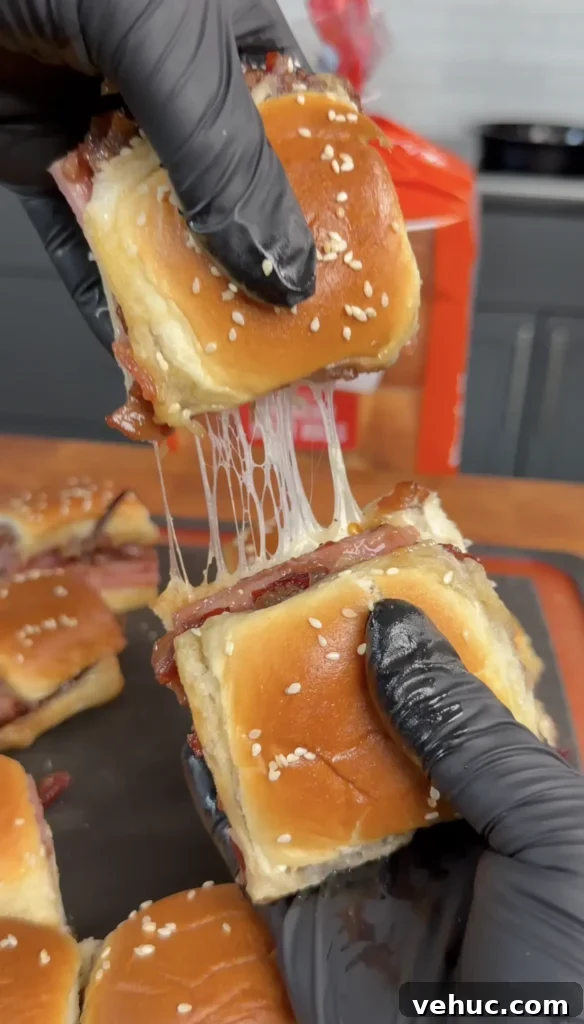 Smoked Ham Sliders with Cranberry Bacon Jam Recipe 2 pulling apart the bacon jam sliders